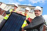 Propetrycare staff with solar panels at BISF scheme in Moss Bank